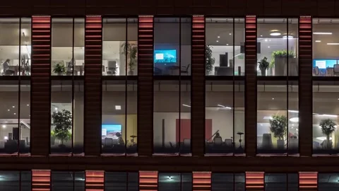 Visible behind the glass facade of an office building, not numerous employees Stock Footage 169371553