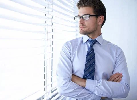 The vision of an ambitious man. A handsome businessman standing in his office Stock Photos
