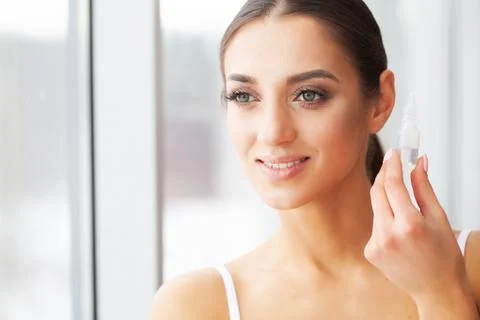 Vision concept. Close-up shot of young woman wearing contact lens Photos