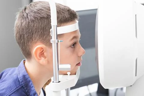Vision correction in a boy. Close-up face of patient boy. Super modern equi.. Foto stock