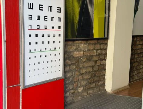 Vision test chart outside optician office. Eye examination, healthcare and op Stock Photos