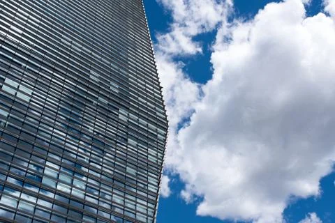 Visionary skyscraper with reflections of clouds on windows Stock Photos