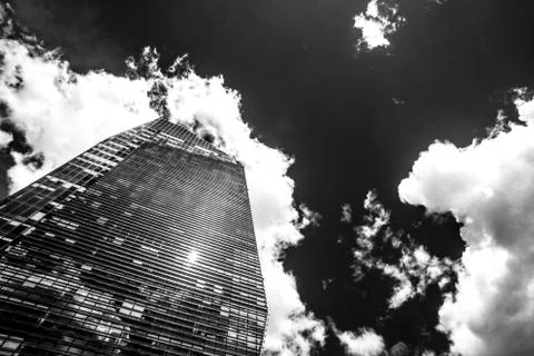Visionary skyscraper with reflections of clouds on windows, monochrome versio Stock Photos