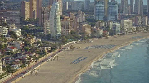 Visit Benidorm to see the beach, buildings, and people enjoying the sun and sand Stock Footage 337151931