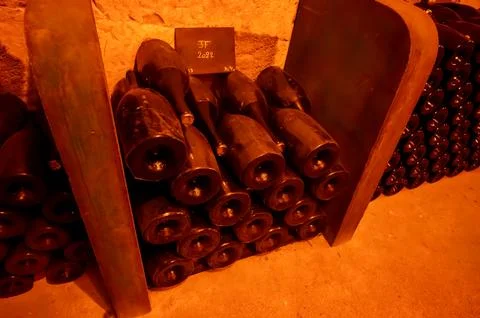 Visit of deep and long underground caves with dusty bottles on racks, tradi.. Stock Photos