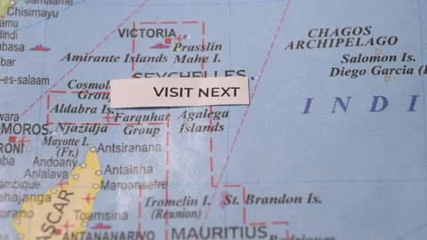 Visit Next text on world map pointing to Seychelles travel vacation concept Stock Footage 346574988