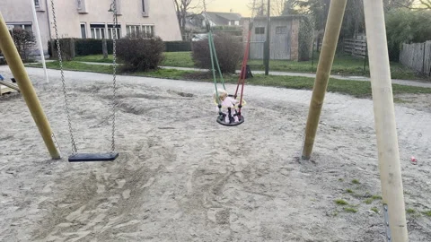 Visit on a playground, a doll on a swing 스톡 동영상 333026206