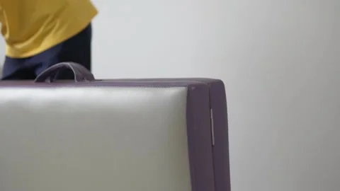 The visiting masseur puts a compact massage table and takes it out of the Stock Footage 154035666