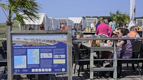 Visitor beach goer Biker St. Peter Ording beach resort, ticket booth, Stock Footage 313807536
