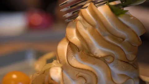 A visitor to a cafe or restaurant breaks off a piece of cream cake with a fork Stock Footage 125364636