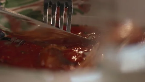 A visitor eats food in red sauce in a restaurant Stock Footage 254482067