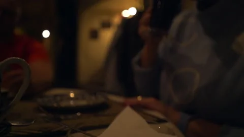 Visitor enjoys drinking red beverage in glass in dark cafe Stock Footage 237370038