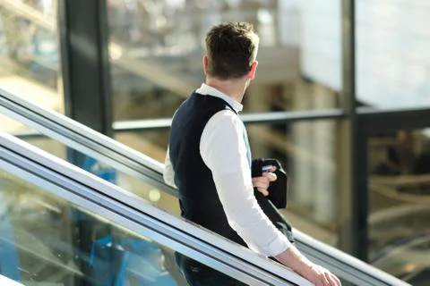 A visitor on the escalator of the exhibition complex Stock Photos