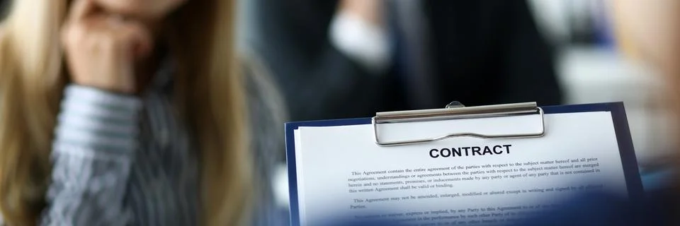 Visitor examining contract application form clipped to pad Stock Photos