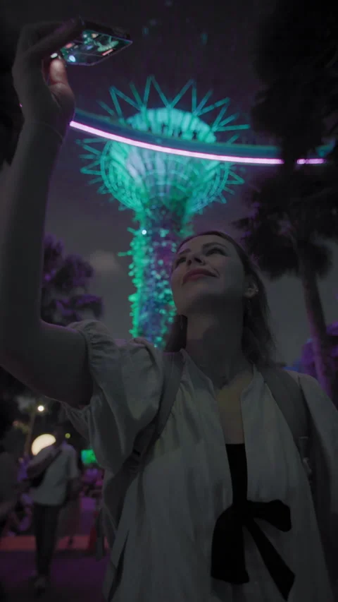 Visitor filming bright tree light show on mobile phone at Gardens by the Bay 库存影片 343669273