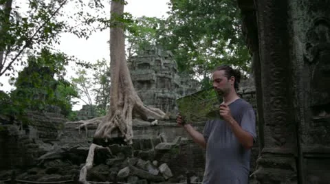 Visitor get bored with guide in Ta Prohm temple, angkor Video stock 12178953