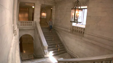 Visitor goes down one of the stairways in New York Public Library Video stock 64608139