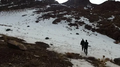 A visitor hiking through the mountain landscape observes, stock footage. Stock Footage 304935588