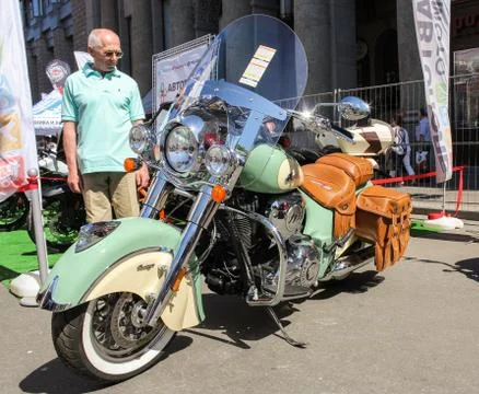 The visitor is looking at a motorcycle. Photos