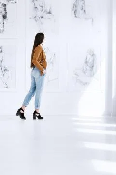 Visitor looking at paintings Stock Photos