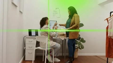 Visitor offering papers, package initiating retail consult while staff seated Stock Footage 333317896