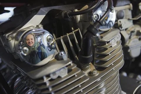 Visitor is reflected in the engine of a vintage motorcycle in Denmark Stock Photos