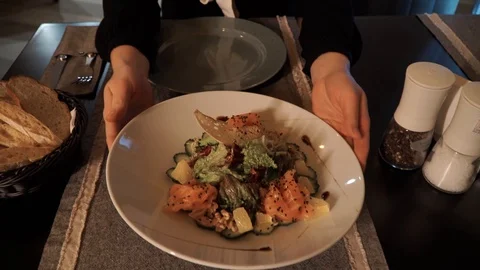 Visitor of the restaurant puts a salad that he ordered near him Stock Footage 121312802