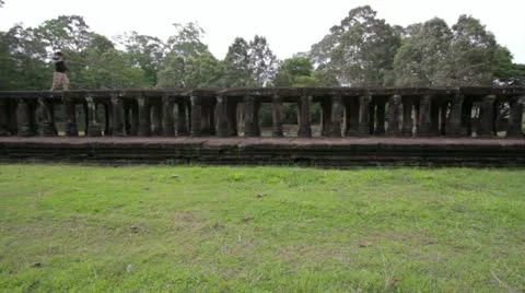 Visitor walking on baphuon temple bridge, angkor, siam reap, cambodia Stock Footage 12172062