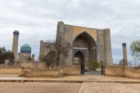 Visitora are in front of Bibi-Khanym Mosque on a cloudy day. Samarkand, Uzb.. Stock Photos
