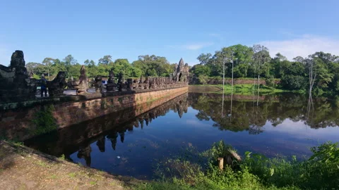 Visitors admire stone statues and historic ruins in Siem Reap Stock Footage 310936064