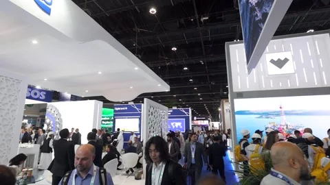 Visitors and atendees moving around ADIPEC 2025 Stock Footage 321046281