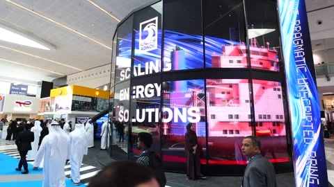 Visitors and atendees moving around ADIPEC 2025 Stock Footage 321046316