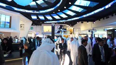 Visitors and atendees moving around ADIPEC 2025 Stock Footage 321046754