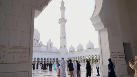 Visitors are seen touring the Sheikh Zayed Grand Mosque in Abu DhabI Stock Footage 321463504