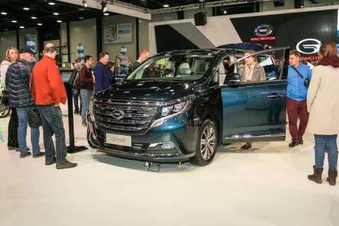 Visitors around the minivan. Photos