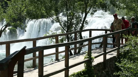 Visitors crossing the bridge and looking Krka waterfall Stock Footage 50582975