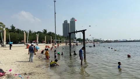Visitors doing activities around the Ancol Beach Jakarta Indonesia Stock Footage 244768867