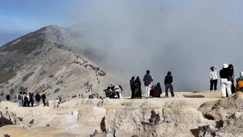 Visitors Enjoy Misty Panorama On Mount Ijen Crater Rim Stock Footage 345144743