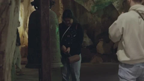 Visitors enjoy a serene cave bell in a breathtaking underground space Stock Footage 312242565