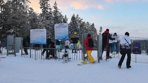 Visitors enjoy skiing at the mountain resort in winter during the afternoon hour Stock Footage 344598112