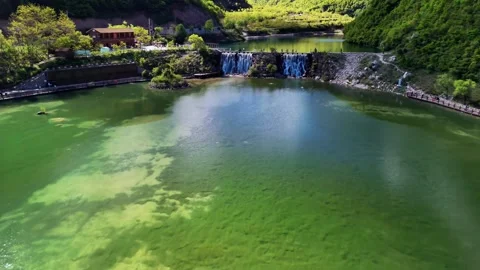 Visitors Enjoying Lush Green Mountain Lake with Man Made Waterfalls Sichuan Stock Footage 346576053