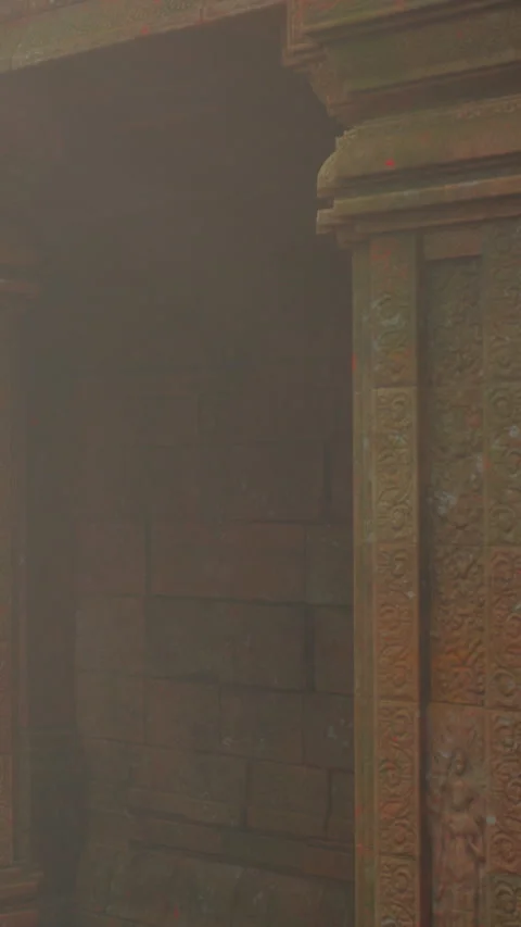 Visitors explore ancient ruins in a dimly lit temple in India Stock Footage 339032588