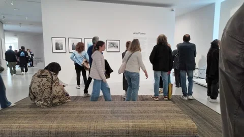 Visitors Explore the Arte Povera Exhibit in a Minimalist Gallery at the Bourse Video stock 299899930