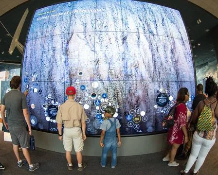 Visitors explore an interactive map of the surface of Mars at the Smithson... Stock Photos