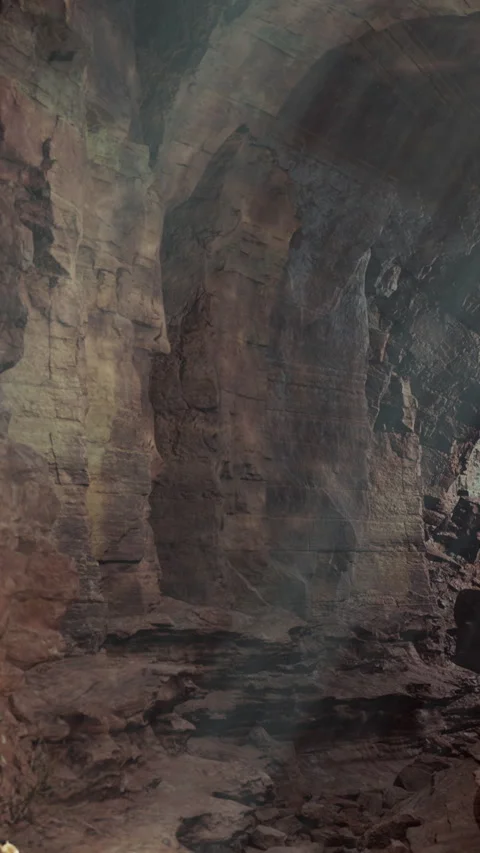 Visitors explore a large cave with rocky walls and light shining through Stock Footage 341963795