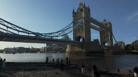 Visitors Explore the Thames Foreshore Beneath Tower Bridge Video stock 338343236