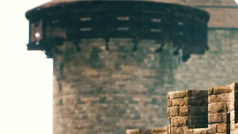 Visitors exploring a historic stone castle with a large tower in the background Stock Footage 345060982