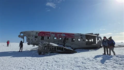 Visitors exploring Icelandic plane wreck in the Winter Stock Footage 332142645
