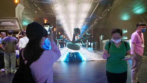 Visitors exploring illuminated technology exhibition at Computex Taipei Stock Footage 335479371