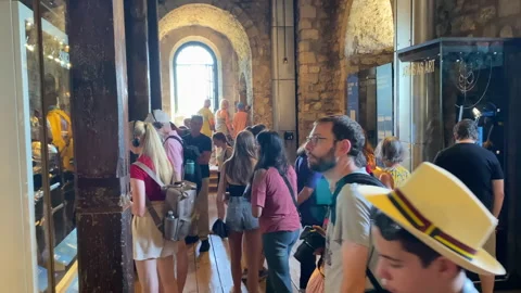 Visitors exploring an interior exhibition inside the Tower of London Stock Footage 321288735